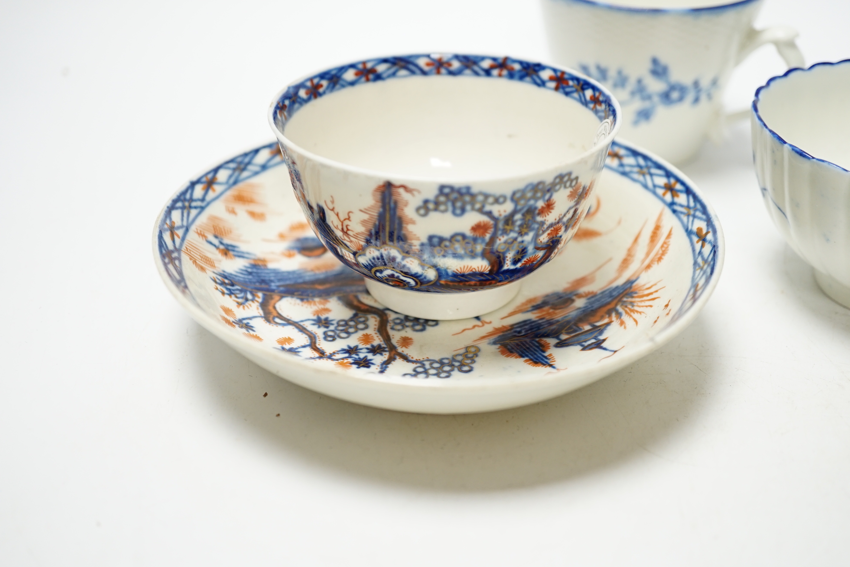 A Worcester James Giles decorated coffee cup, c.1765-70, a Caughley reeded tea bowl, a Pennington tea bowl and saucer and a coffee cup, tallest cup 6.5cm (4)